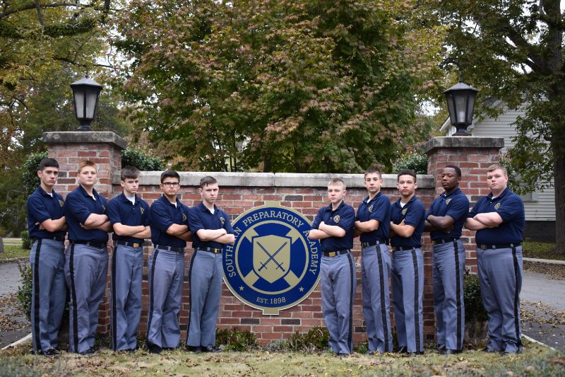 cadets standing at southern prep brick gate
