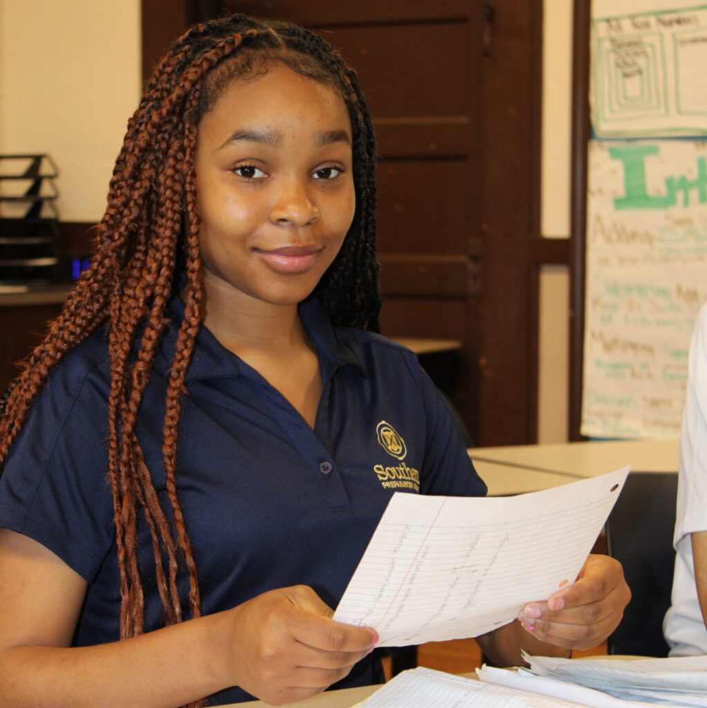 A female student at Southern Preparatory Academy studies in the classroom.