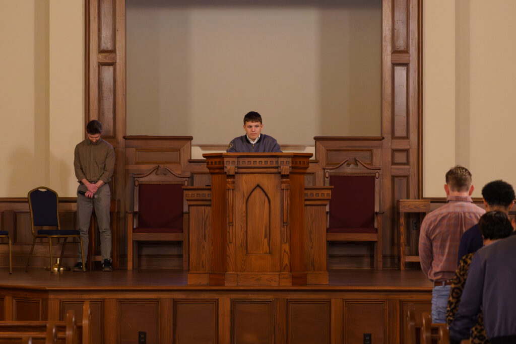 A Southern Preparatory Academy student leads a morning prayer during a weekly chapel service in the on-campus chapel.